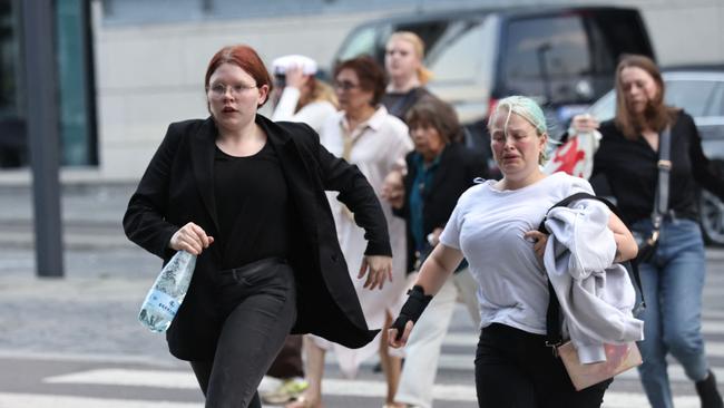 People are seen running during the evacuation of the Fields shopping center in Copenhagen. Picture: AFP