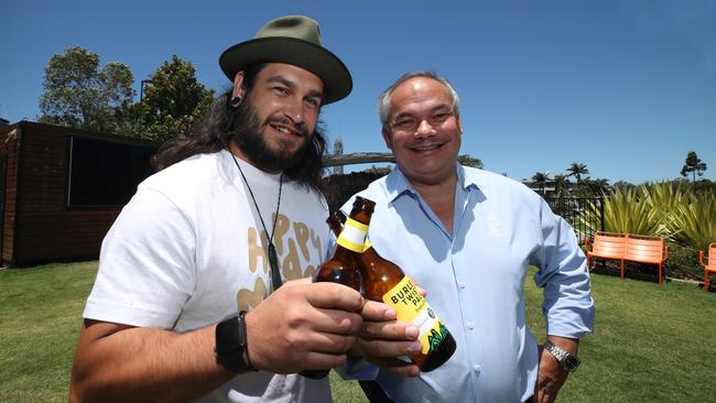 Maudsland man Jayson Huthmann-Grace sharing a congratulatory beer with Mayor Tom Tate at HOTA Cafe after crash tacking an alleged car thief at Labrador. Picture Glenn Hampson