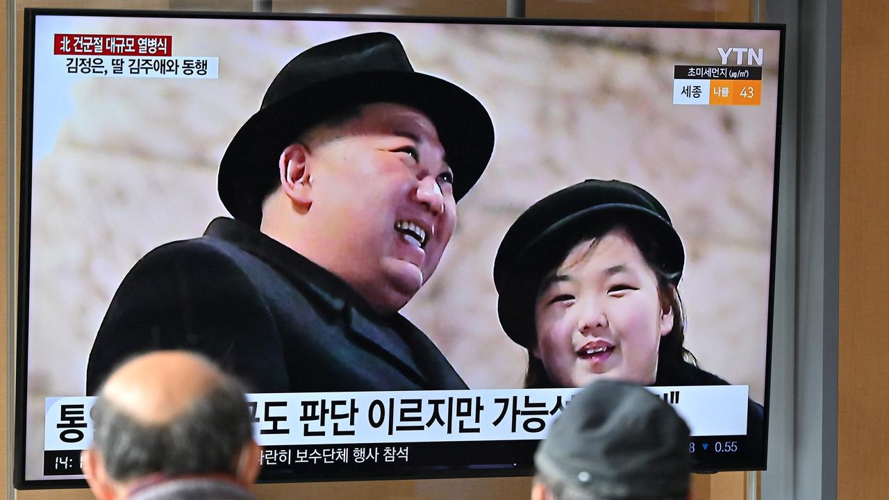 People watch a TV screen showing a news broadcast with an image of North Korean leader Kim Jong-un and his daughter presumed to be named Ju Ae. Picture: Jung Yeon-je/AFP