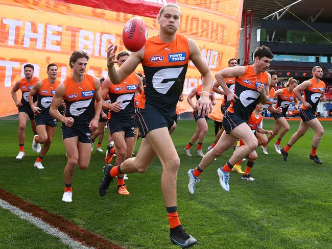 Harry Himmelberg runs through the banner for a Giants home game. Picture: Jason McCawley/AFL Photos/via Getty Images