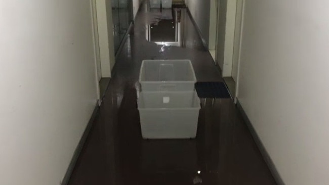 Containers catching water from a leaking roof during rain. Picture: 9 News