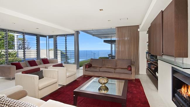 The living room has an ocean backdrop.