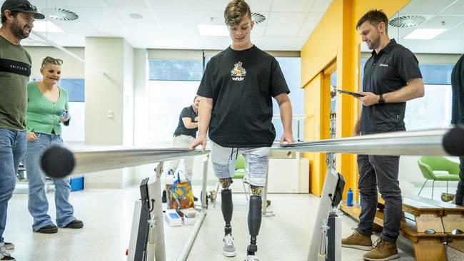 Ted, 15, receives his new robot prosthetics. Picture: Jake Nowakowski