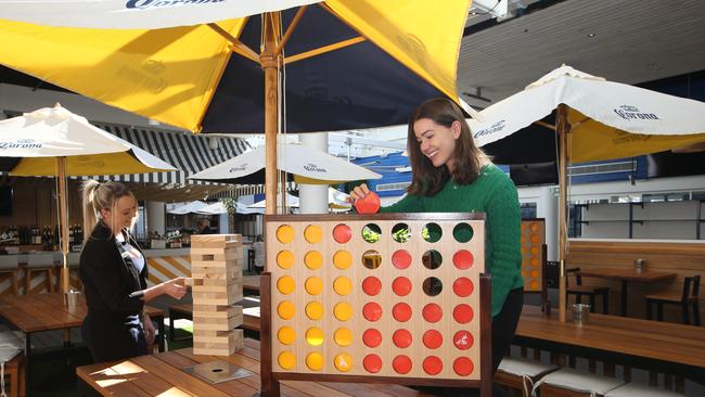 Larissa Burgess and Philippa Arrowsmith try some of the games. Picture: Glenn Hampson