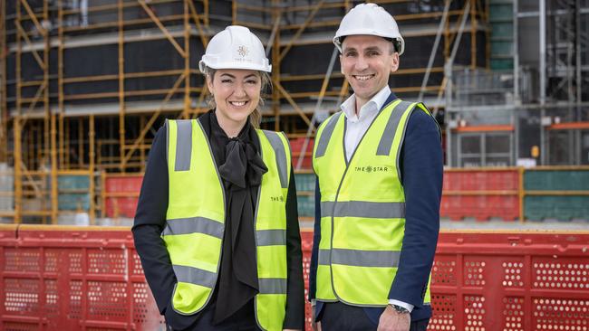 Jess Mellor and Silas Croucher beside The Star Gold Coast's $400 million tower. Picture: Remco Jansen