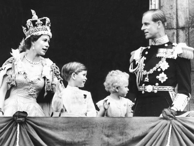 A young Prince Charles and Princess Anne try out their royal waves. Their mother’s Coronation was also marked by an RAF flypast above The Mall, and while the focus was inevitably on events in London, street parties were held around the nation.