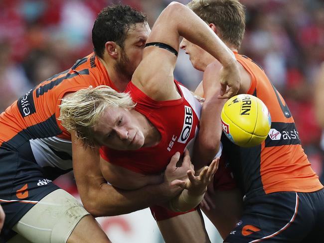Sydney's Isaac Heeney under pressure from Giants Shane Mumford, Joel Patfull and Lachie Whitfield during AFL match Sydney Swans v GWS Giants at SCG. Picture. Phil Hillyard