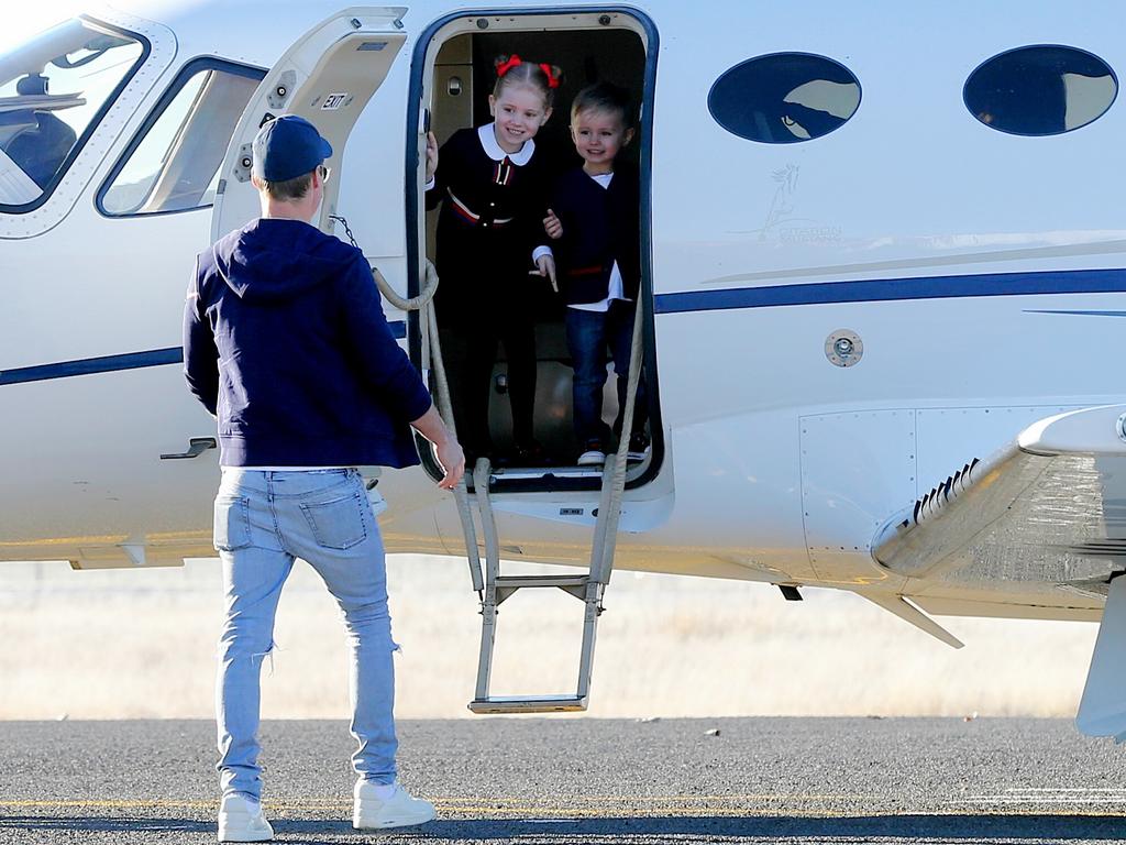 Oliver Curtis greets his children in the tarmac in their private jet. PR queen Roxy Jacenko and children at Cooma Airport to pick her husband Oliver Curtis after being released after serving time for insider traiding at Cooma Correctional Centre. Pic Stephen Cooper