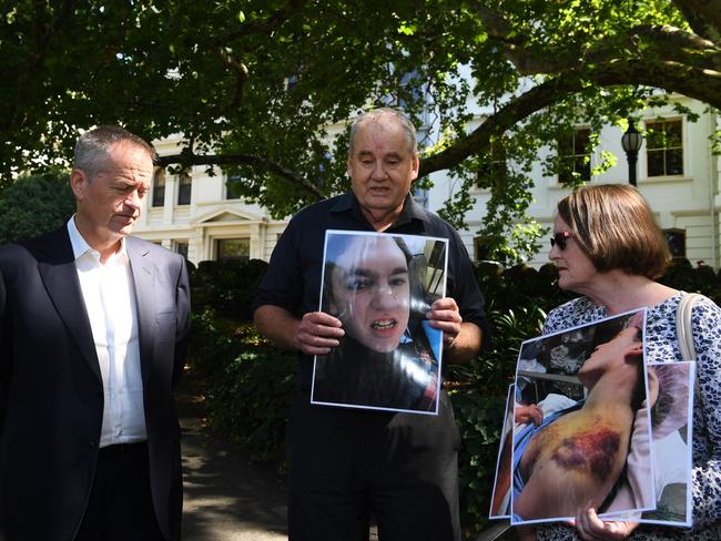 Opposition Leader Bill Shorten with parents holding photos of their 33-year-old son who was abused in the care of the Victorian Department of Human Services in Melbourne last Saturday. Picture: AAP