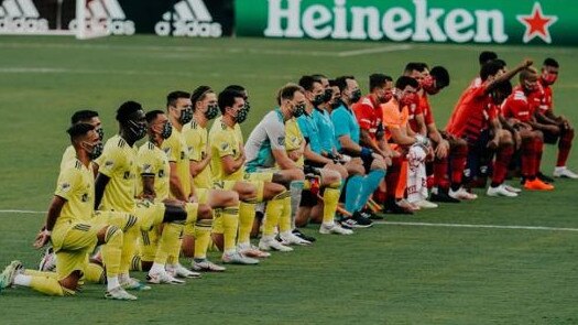 MLS players kneel before the Dallas-Nashville match.