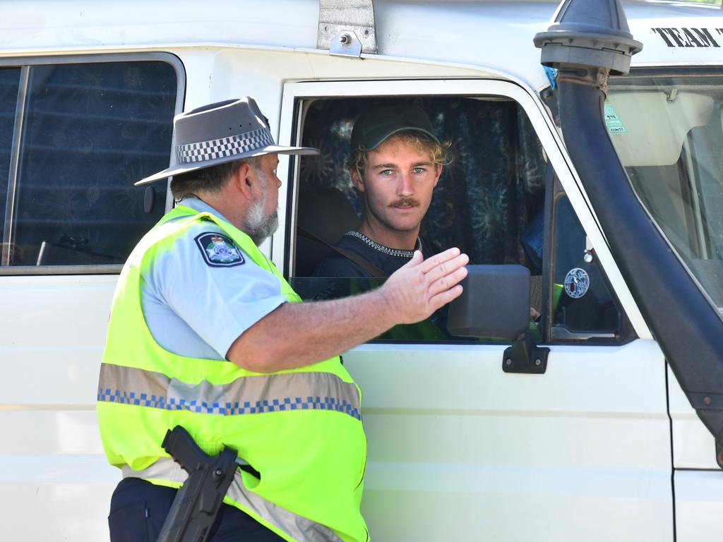 A policeman is seen talking to a driver at a check point on the Queensland and New South Wales border. Picture: Darren England/AAP