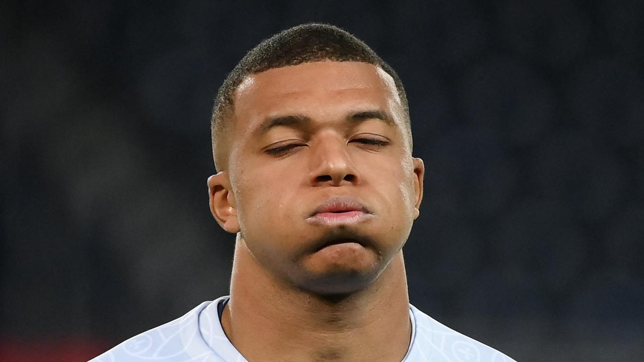 TOPSHOT - Paris Saint-Germain's French forward Kylian Mbappe reacts as he warms up prior to the UEFA Champions League group H football match between Paris Saint-Germain (PSG) and SL Benfica, at The Parc des Princes Stadium, on October 11, 2022. (Photo by FRANCK FIFE / AFP)
