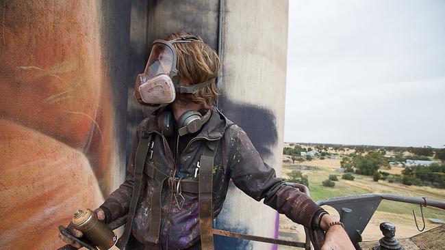 Artist Matt Adnate at work on the Sheep Hills silo.