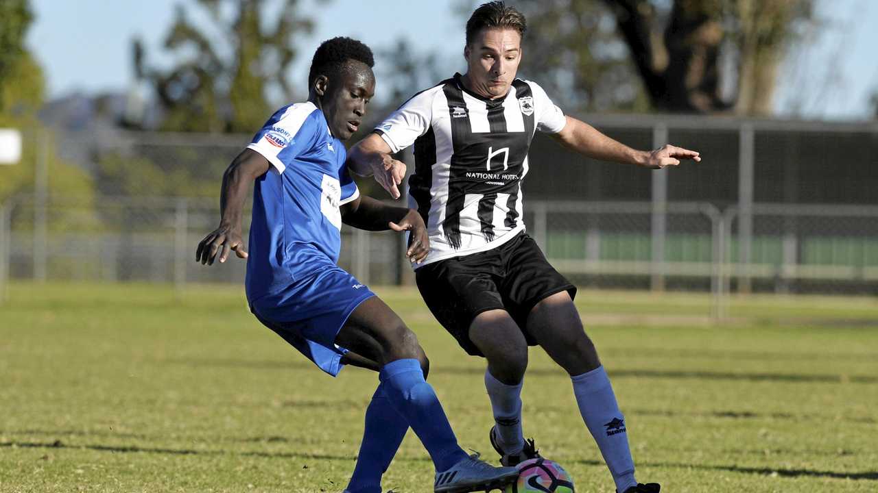 SPECIAL GAME: Rockville's David Oyori (left) and Willowburn's Mitchell Tanskey tussle for possession during last year's inaugural Jake Simpson Memorial Match. Picture: Kevin Farmer