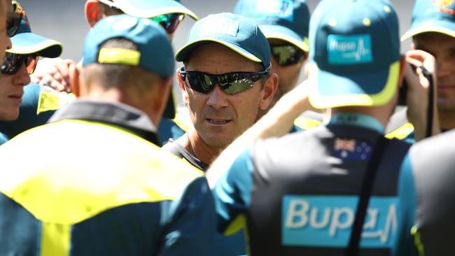 New Australia coach Justin Langer talks to his players.