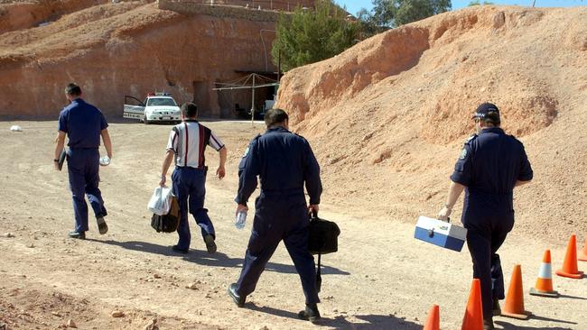 Police officers at Dugout house on Blacktop Hill Road at Coober Pedy where victim Andrew "Wilbur" Williamson was found dead in 2003.