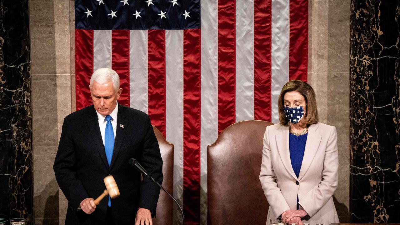 Mr Pence and Ms Pelosi on Wednesday night, after law enforcement regained control of the Capitol. Picture: Erin Schaff/AFP