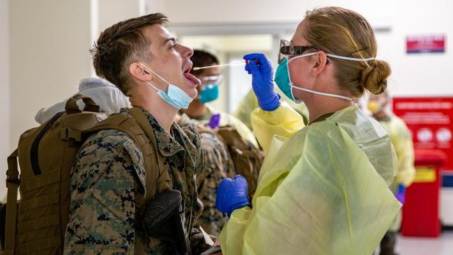 A US Marine part of the final wave arrives at RAAF Base Darwin and undergoes COVID-19 testing on Friday, before being transported to his quarantine quarters. Picture: Sarah Marshall