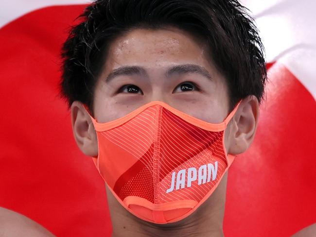 TOKYO, JAPAN - JULY 28: Daiki Hashimoto of Team Japan celebrates his victory with the Japan Flag during the Men's All-Around Final on day five of the Tokyo 2020 Olympic Games at Ariake Gymnastics Centre on July 28, 2021 in Tokyo, Japan. (Photo by Laurence Griffiths/Getty Images)