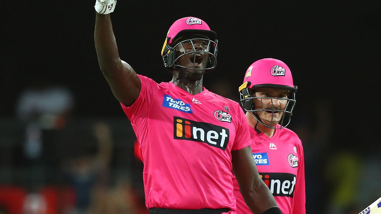 GOLD COAST, AUSTRALIA - DECEMBER 29: Jason Holder and Ben Manenti of the Sixers celebrate winning the Big Bash League match between the Melbourne Renegades and the Sydney Sixers at Metricon Stadium, on December 29, 2020, in Gold Coast, Australia. (Photo by Chris Hyde/Getty Images)