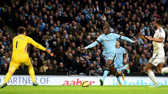 Manchester City's Ivorian midfielder Yaya Toure (C) scores his team's second goal.