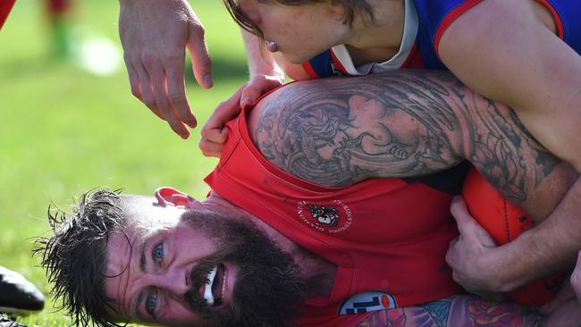 Brad Perry gets tackled by Brody Tardio during the NFL Division 2 grand final between North Heidelberg and Diamond Creek. Picture: Andy Brownbill.  