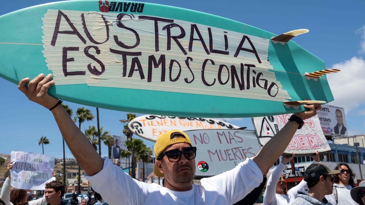 Signs read “Australia we are with you” and “No more death”. Picture: Guillermo Arias / AFP