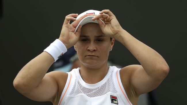 Australia's Ashleigh Barty adjusts her cap during a break in a women's singles match against United States' Alison Riske during day seven of the Wimbledon Tennis Championships in London, Monday, July 8, 2019. (AP Photo/Ben Curtis)