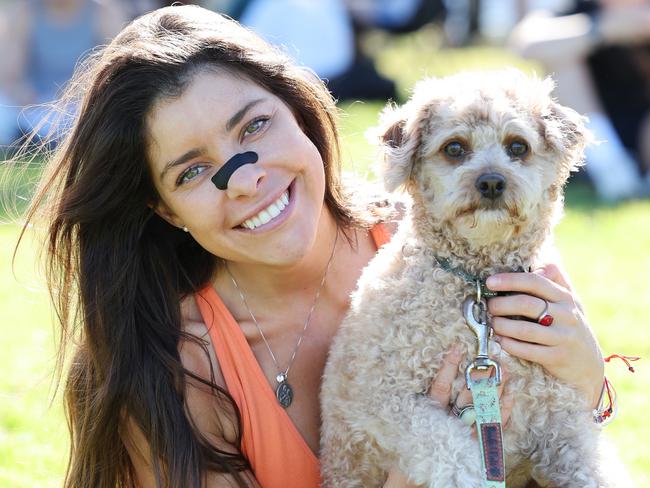 Constanza Tirado-Subiabre tries a nose strip while walking Bruno at Bondi. Picture: Rohan Kelly
