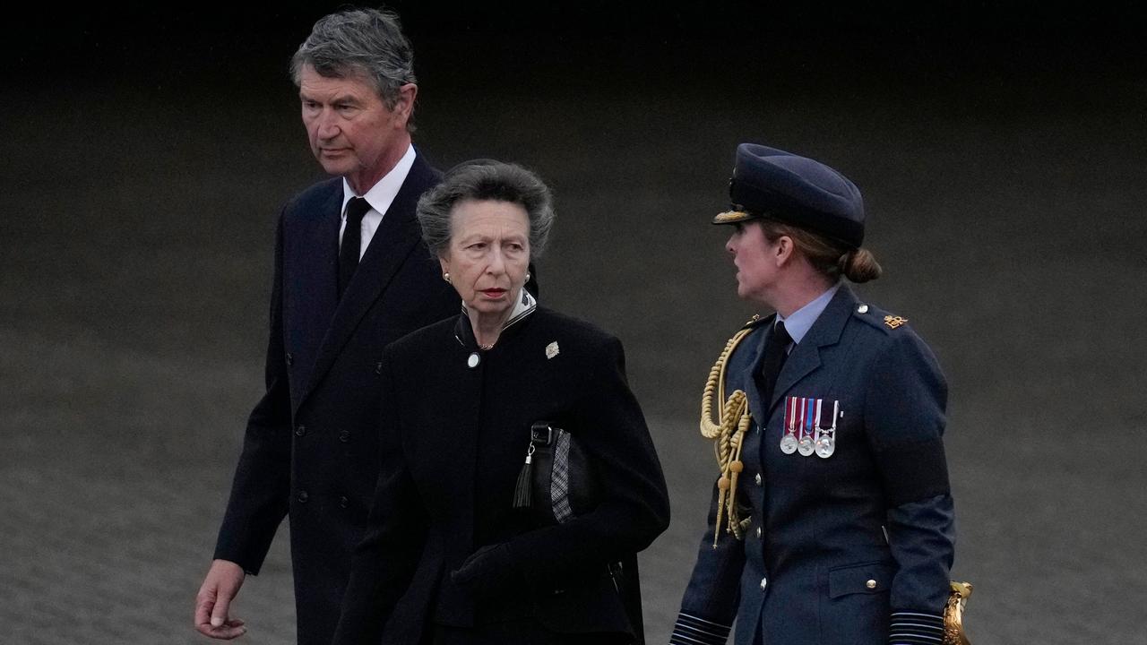 Princess Anne, Princess Royal, and Vice Admiral Sir Timothy Laurence are greeted by Station Commander Group Captain McPhaden. (Photo by Kirsty Wigglesworth / POOL / AFP)