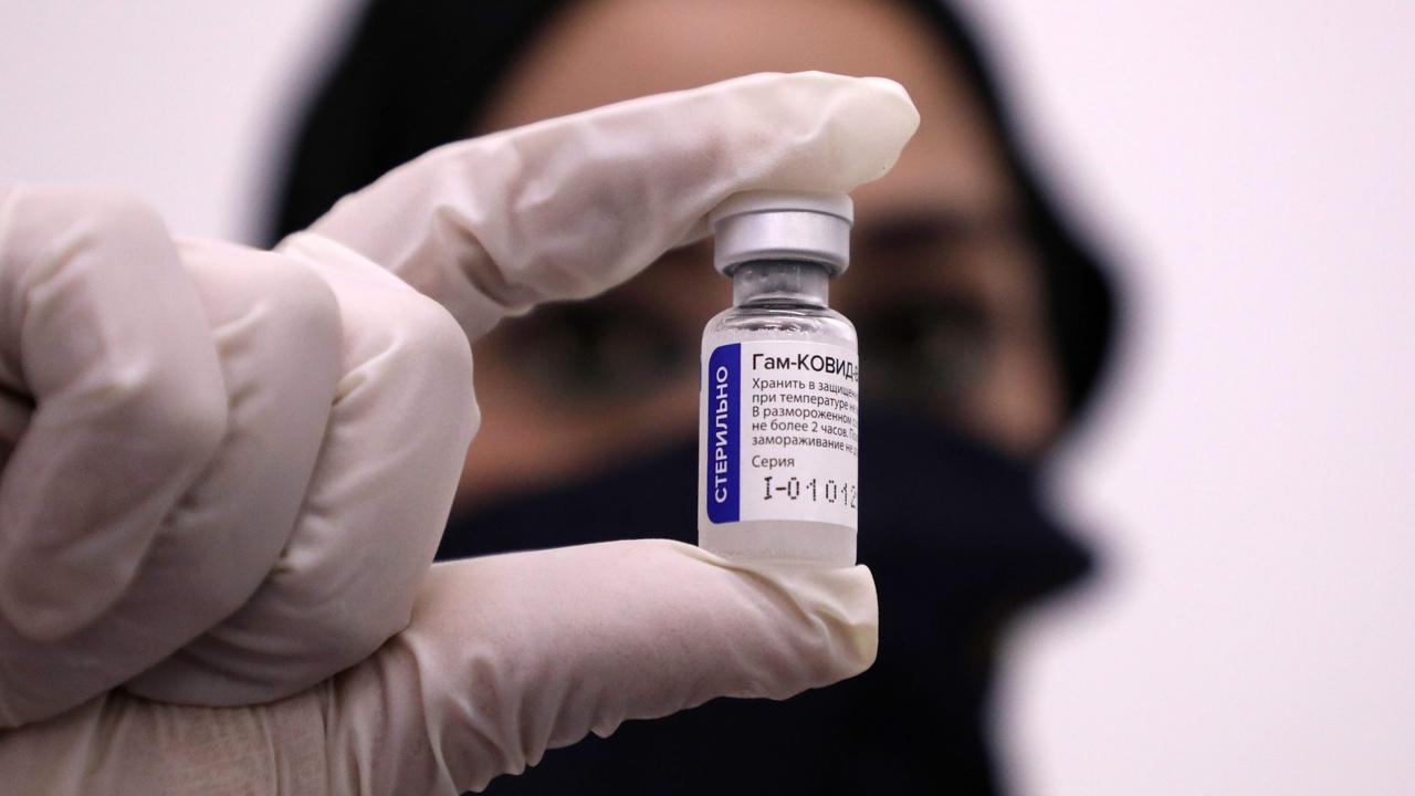 A Palestinian Red Crescent health worker displays a vial of Russian Sputnik V COVID-19 vaccine in the West Bank city of Hebron, on February 11, 2021. Picture: HAZEM BADER / AFP.