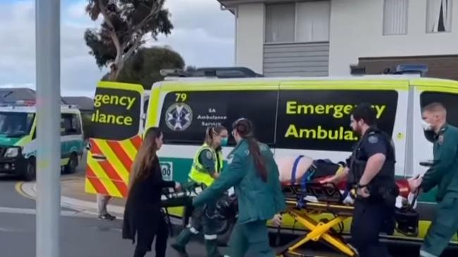 Paramedics with the man injured in the hit run at Andrews Farm. Picture: 7NEWS