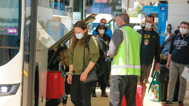 Arrivals from COVID-19 hotspots at Darwin International Airport en route to mandatory quarantine. Picture: Glenn Campbell