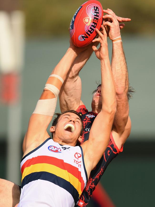 Tom Doedee of the Crows marks in front of Tim Smith of the Demons in Alice Springs. Picture: Quinn Rooney/Getty Images