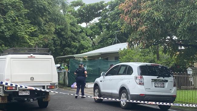 Police establish a crime scene in Marchant Street, Cairns, where a man was found stabbed to death on Friday night.