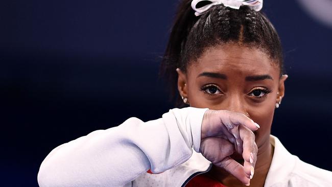 (FILES) In this file photo taken on July 27, 2021 USA's Simone Biles gestures during the artistic gymnastics women's team final during the Tokyo 2020 Olympic Games at the Ariake Gymnastics Centre in Tokyo. - Simone Biles withdrew from Olympics all-around gymnastics on July 28, 2021. (Photo by Loic VENANCE / AFP)