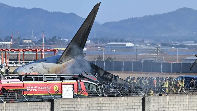 Firefighters and rescue team members work on the runway of Muan International Airport. Picture: Lee Young-ju/Newsis via AP