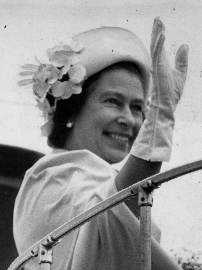 RThe Queen waves from atop the aircraft stairs as she departs by aeroplane from Adelaide Airport, headed for Port Moresby, Papua New Guinea on March 23, 1977.