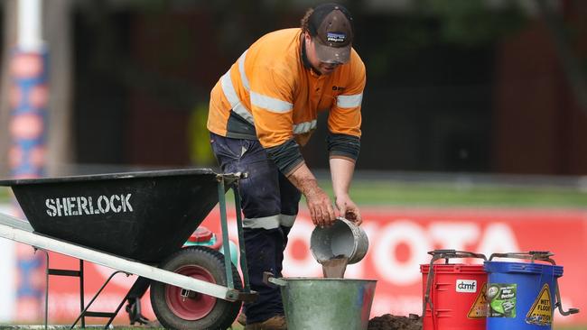 MELBOURNE, AUSTRALIA - OCTOBER 20: Ground staff work on a broken water main on the field of play ahead of the round eight AFLW match between Collingwood Magpies and Adelaide Crows at Victoria Park, on October 20, 2024, in Melbourne, Australia. (Photo by Daniel Pockett/Getty Images)