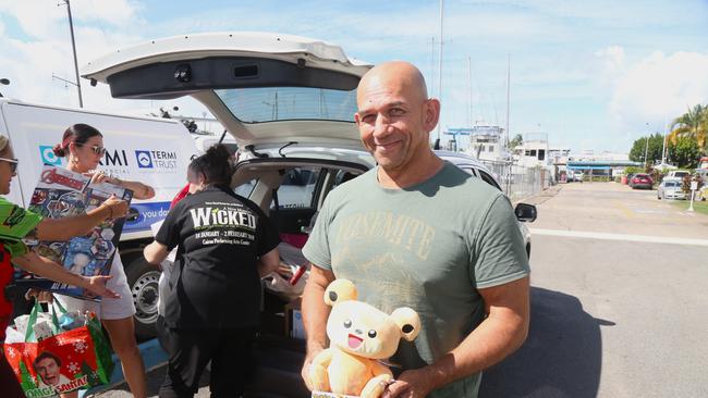 Carlton Nicholas from Ignite Endurance makes a donation to the Cairns Community Flood Appeal 2023 at the Cairns Cruising Yacht Squadron base in Portsmith. Picture: Peter Carruthers