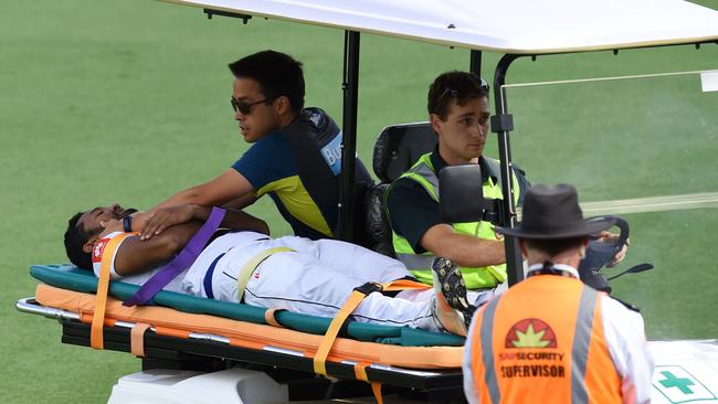 Sri Lanka’s Dimuth Karunaratne is taken from the ground on a motorised stretcher. Picture: AFP