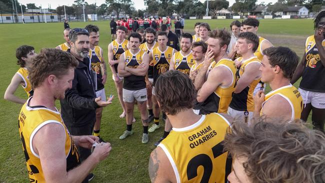 YCW coach Paul Goonan chats to his players on the ground after their win. Picture: Valeriu Campan