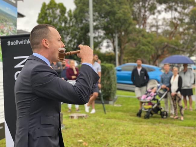 Auctioneer Andrew Cooley drops the hammer at $1.265 million on a house on Jacana Grove in Heathcote on December 19, 2020. NSW real estate.