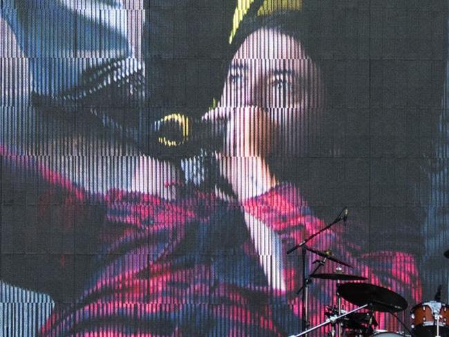 A screen shows singer of US band "Foo Fighters" Dave Grohl in the background of the empty stage during the band's concert att Nya Ullevi in Gothenburg, Sweden, on June 12, 2015. Grohl broke his leg while performing on stage in Gothenburg. AFP PHOTO / TT NEWS AGENCY / ERIK ABEL SWEDEN OUT