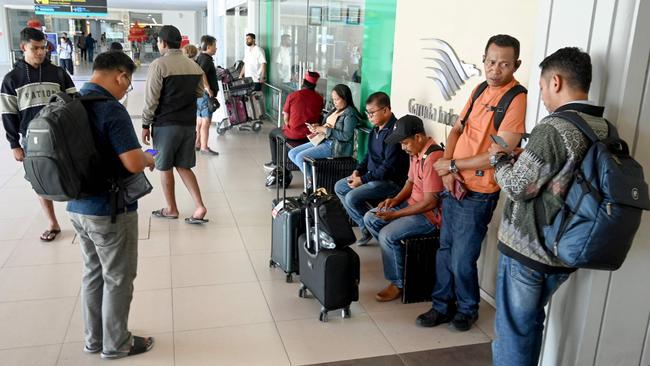 Passengers whose domestic flights were cancelled wait at the Ngurah Rai International Airport. Picture: AFP