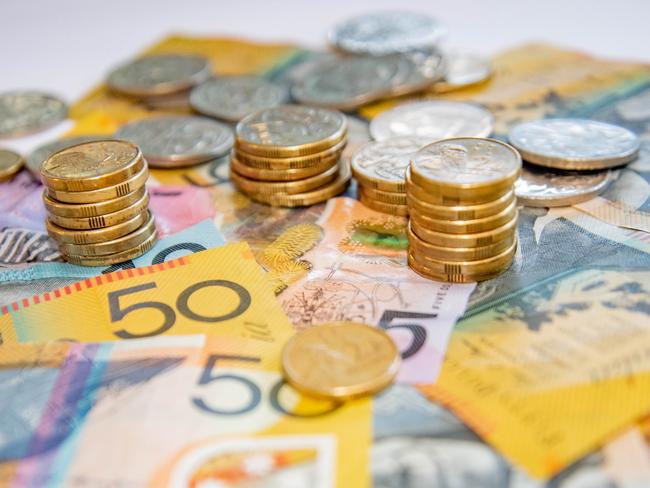 Australian notes and coins spilled out on a table, money cash generic