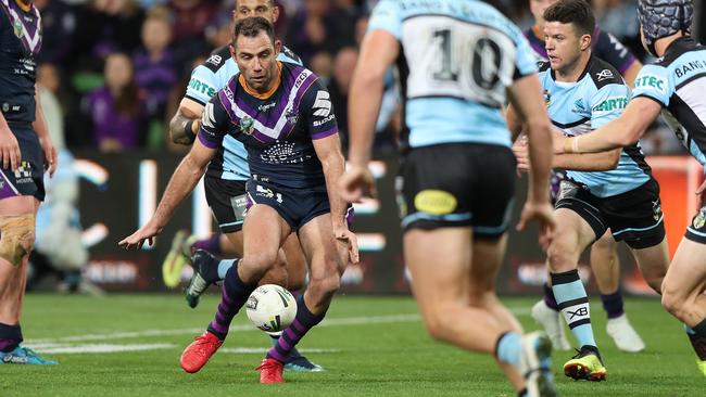 Cameron Smith kicks to set up a try for Storm teammate Billy Slater. Picture: Brett Costello