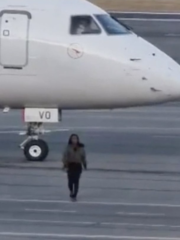 Shockingly, she also walked under the plane. Photo: 9 News