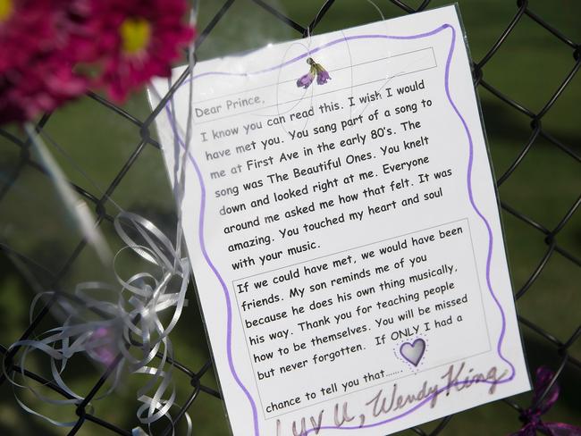 A note, left by a fan, is attached to the fence which surrounds Paisley Park. Picture: Scott Olson/Getty Images/AFP.