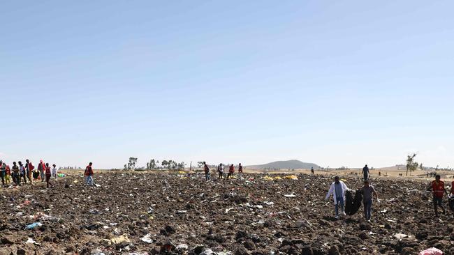 A rescue team at the crash site. Picture: AFP.